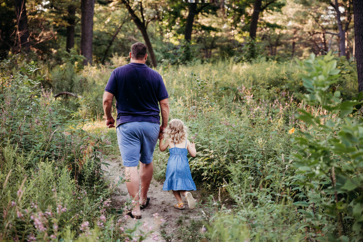 Father and daughter walking through wildflower path in Toronto Park