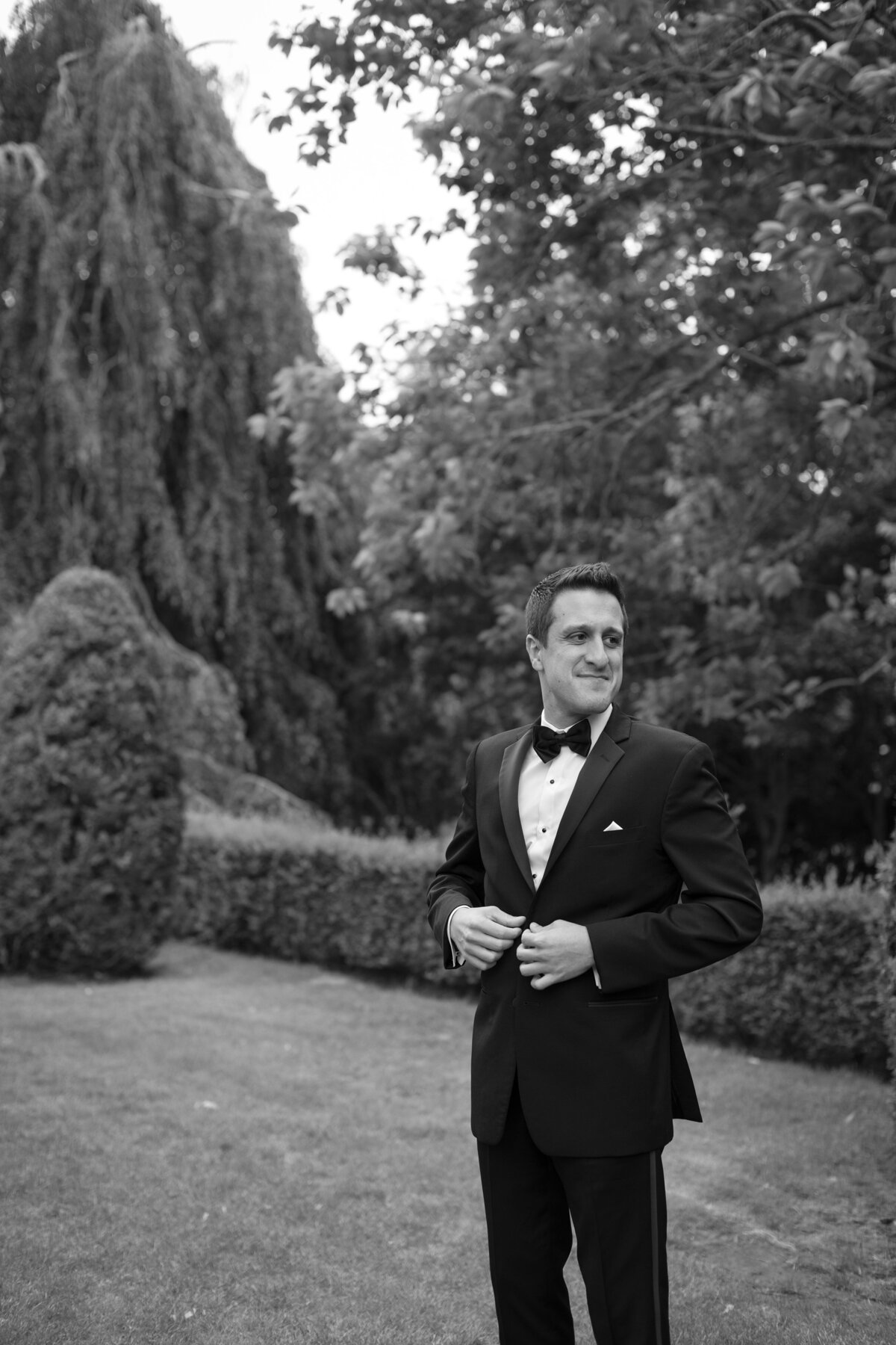 Groom poses on the grounds of the Elms Mansion in Newport, Rhode Island.