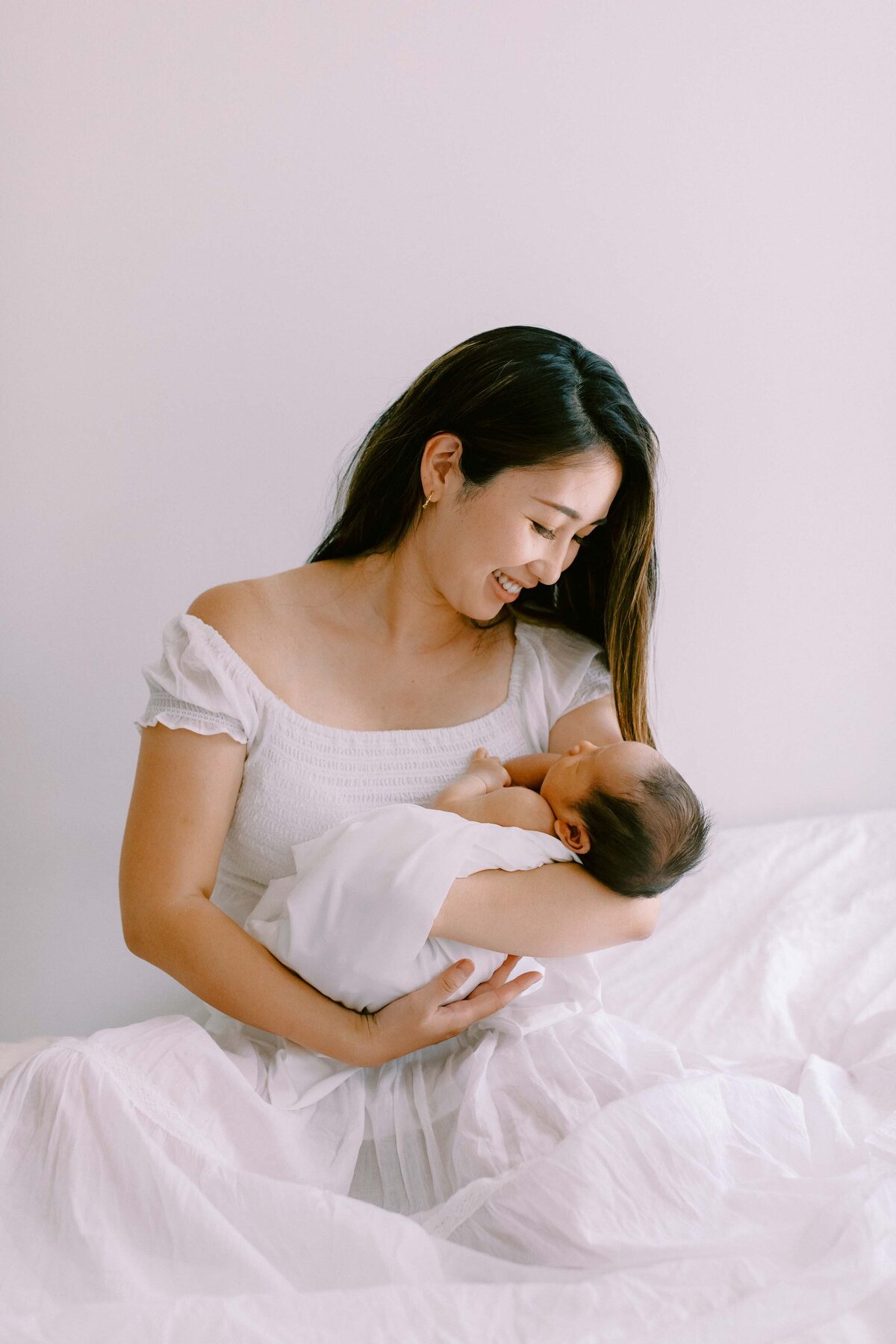 new mom looking lovingly at her newborn son