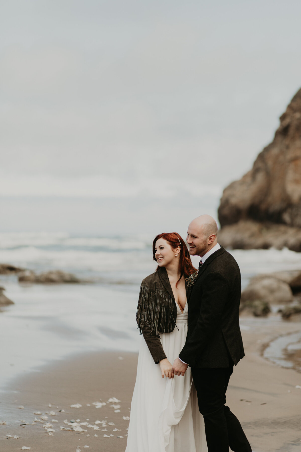 Couple happy next to the ocean after elopement in Cannon Beach, OR
