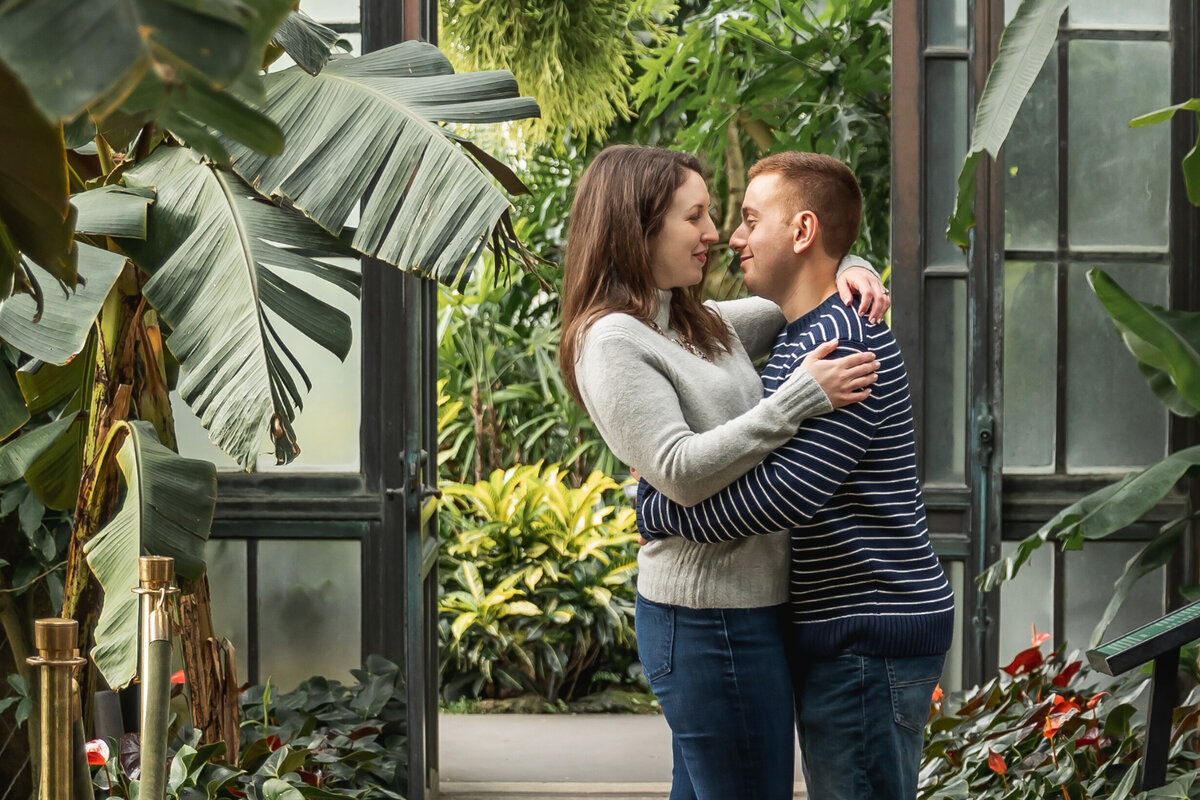 engaged couple hugging longwood gardens, kennett square, Pa
