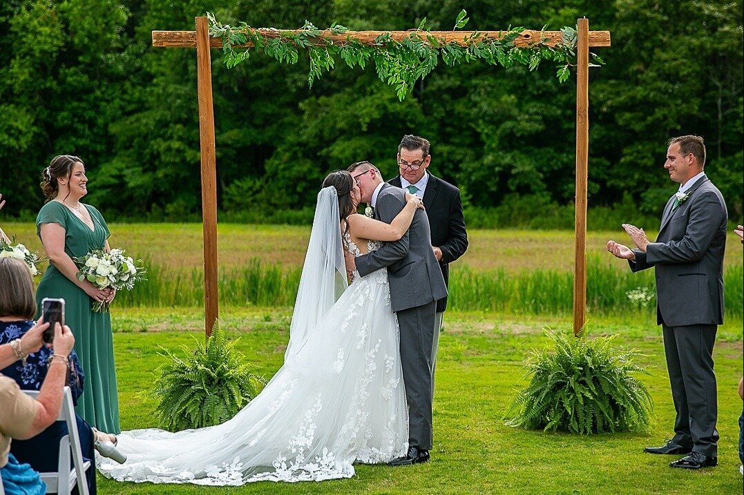 Bride-Groom-Kissing-Wedding-Ceremony-Arbor-Legacy-at-Willow-Pond-Wedding-Virginia.JPG