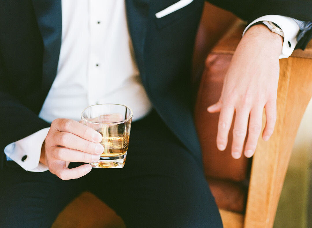 Groom Holding Cocktail Photo