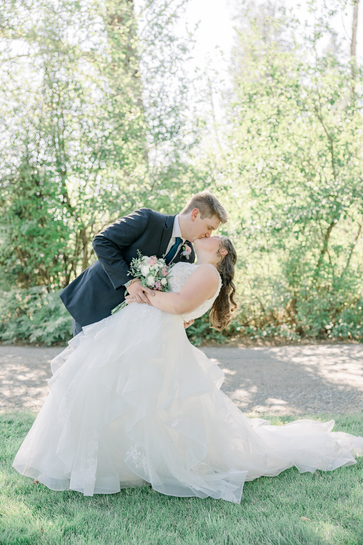 bride and groom sharing a dip kiss on their wedding day