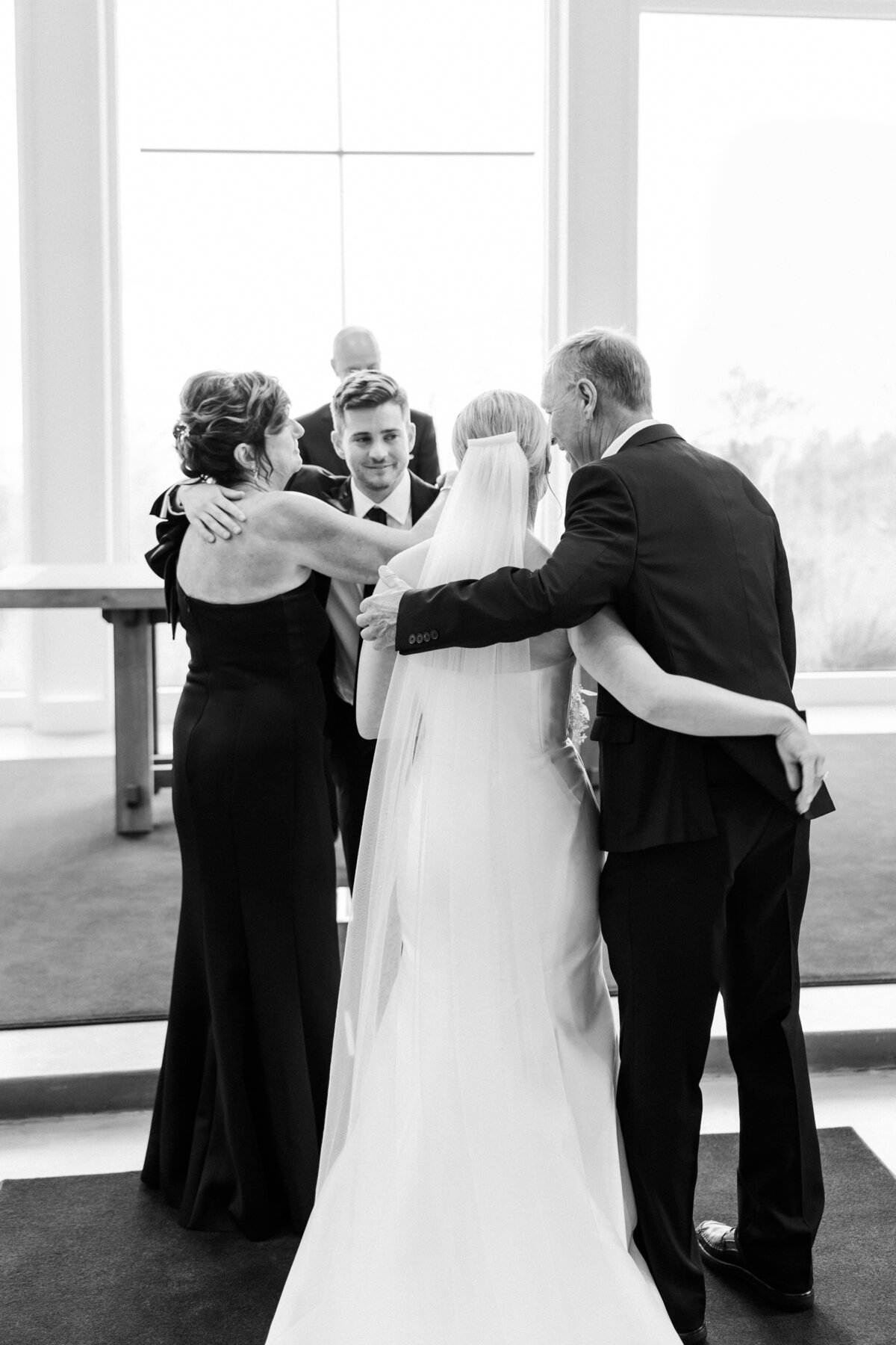 24-wedding-couple-hugging-parents