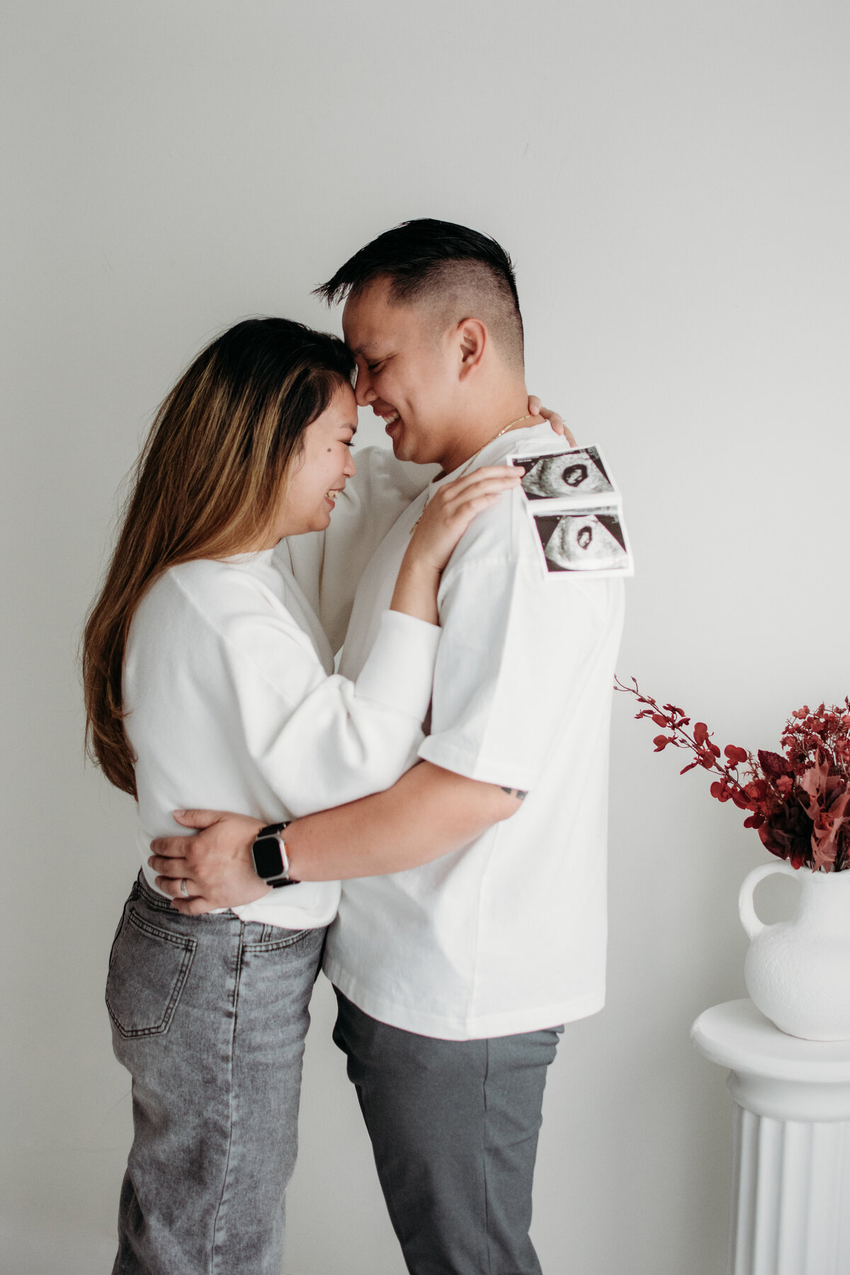 Gentle embrace of a soon to be parents during a studio photoshoot in Bartlett, IL
