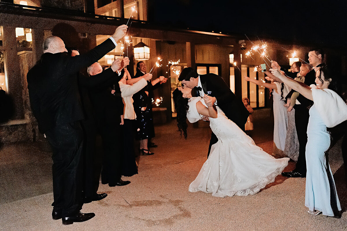 Bride and groom share a kiss during their Sparkler Grand Exit at the  Broadmoor hotel in Colorado Springs, Colorado.