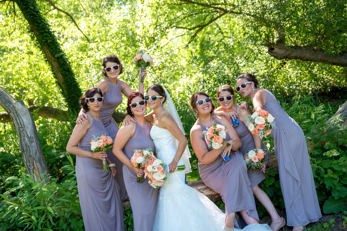 Bridesmaids wearing sunglasses during photo session.