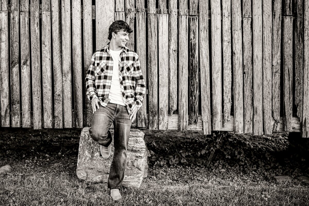 senior-guy-posing-on-barn