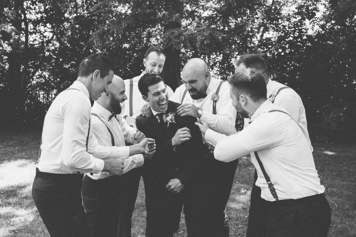groomsmen having fun with the groom