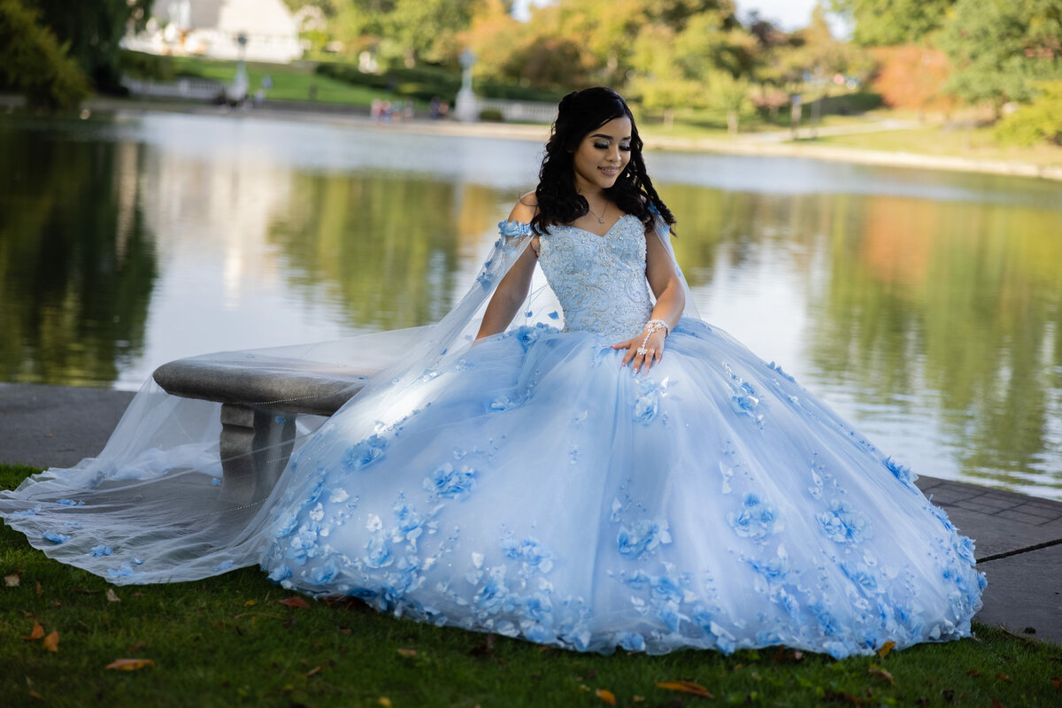 A stunning portrait of Victoria in her beautiful blue quinceañera gown by the lake at University Circle in Cleveland, Ohio. The perfect blend of elegance and nature captured by TheWiz Photography.