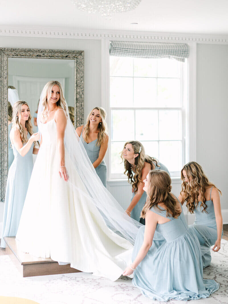 Bride surrounded by bridesmaids to show planning a wedding in chicago