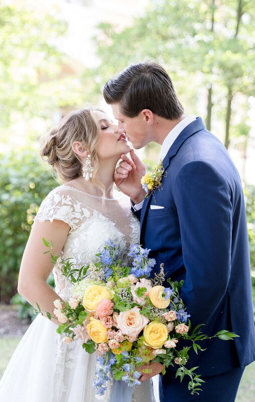 Bride and groom walk in ocean side garden at Whispering Rose Ranch at sunset