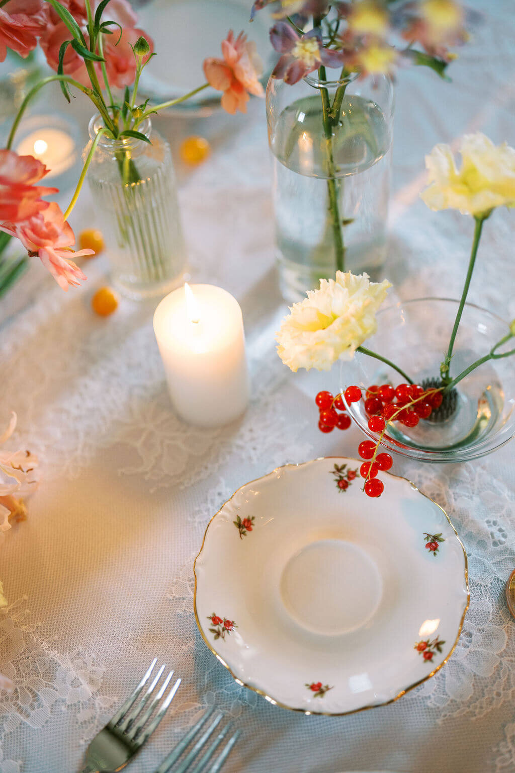 Vintage flatware and plates with red and white flowers