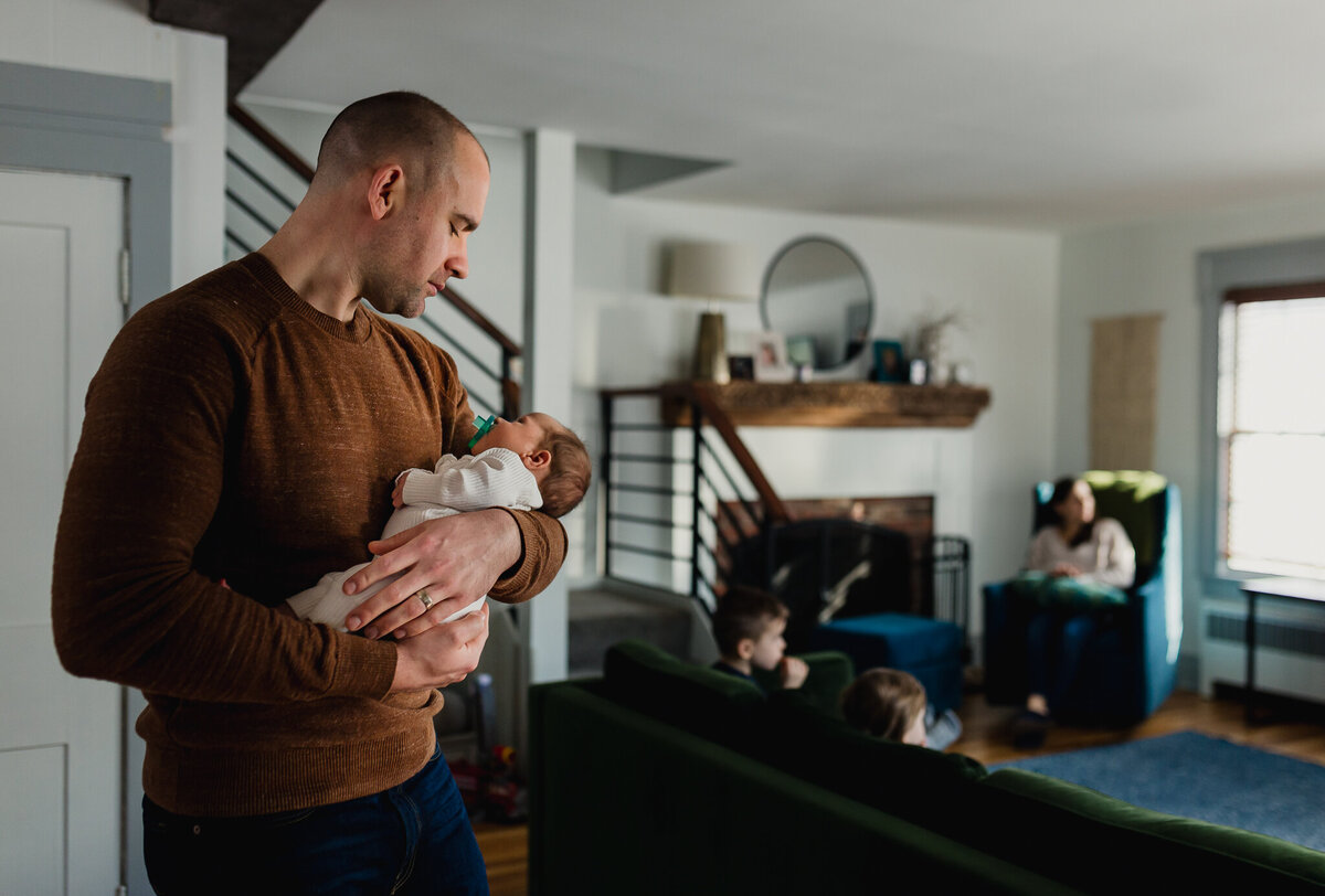 Family Photoshoot Session with dad holding newborn baby.