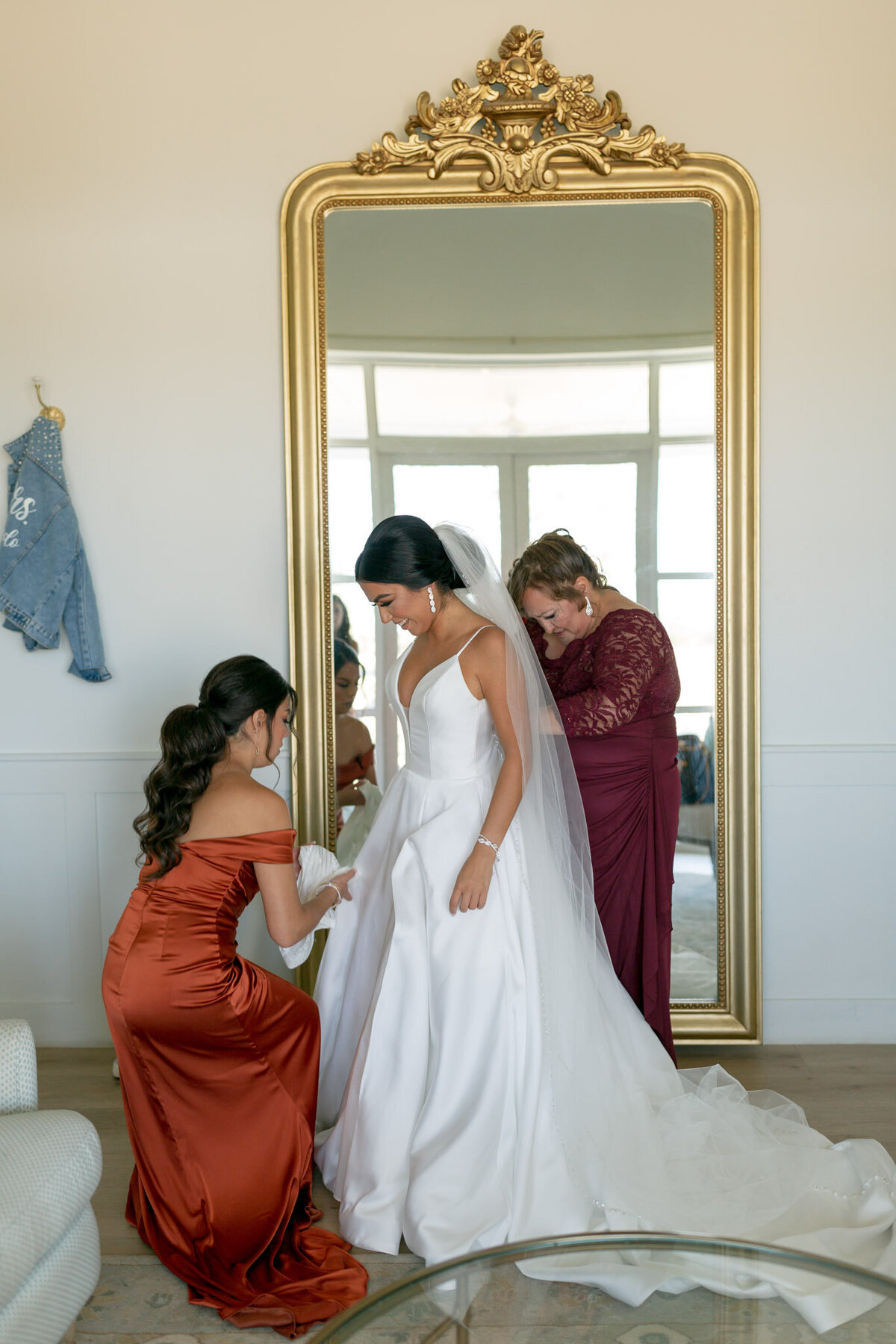 bride getting help putting on dress