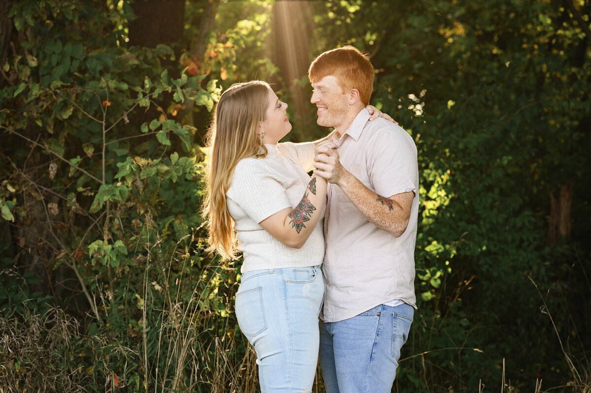 A beautiful couple sharing a dance moment, captured in a serene outdoor setting by Leslie Q Photography