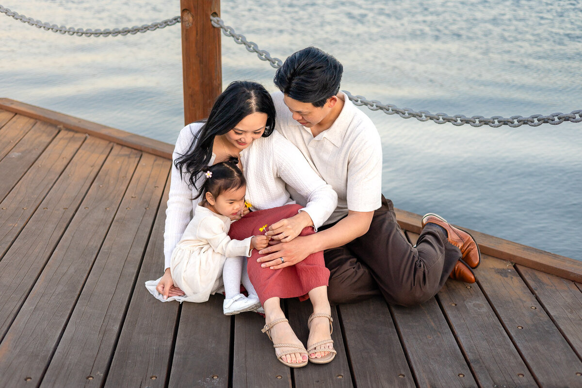 Family sitting on a wooden dock at San Francisco Bay enjoying a quiet candid moment – Bay Area Family Portfolio – Ellobelle Photography