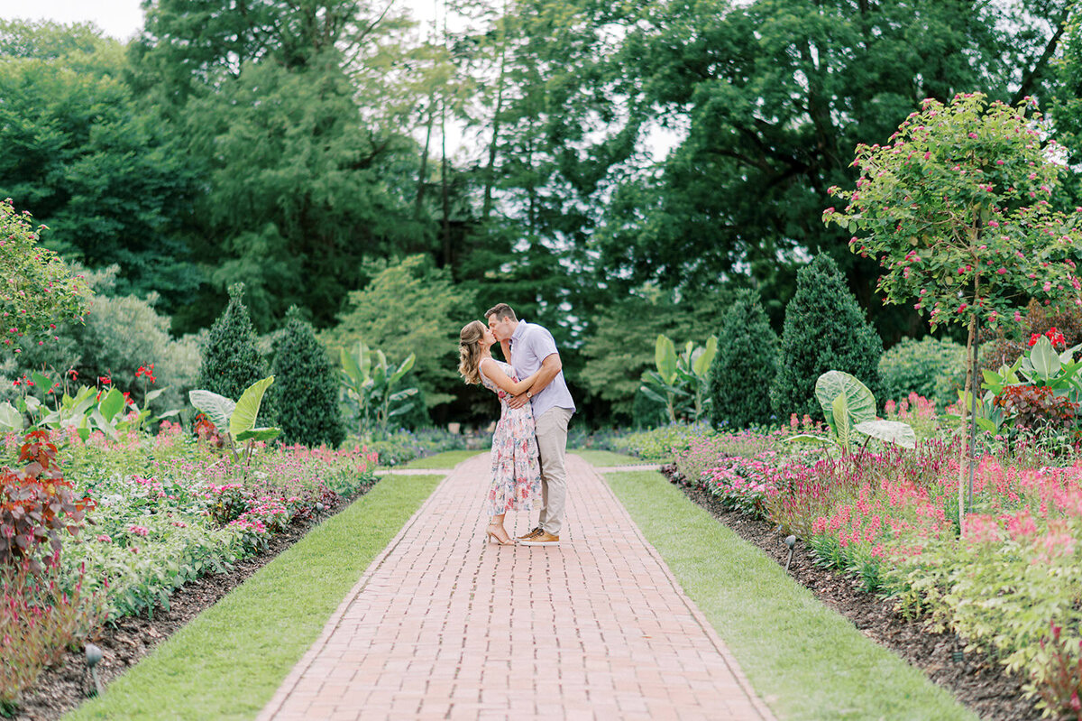 A couple at their floral engagement at Longwood Gardens in Kennett Square, PA