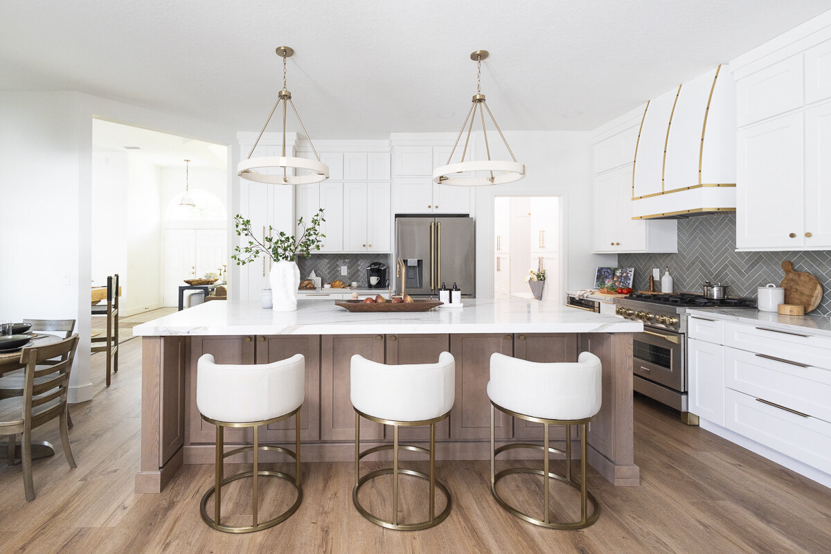 dewine design interiors belle isle project kitchen with wooden floors and white and gold barstools