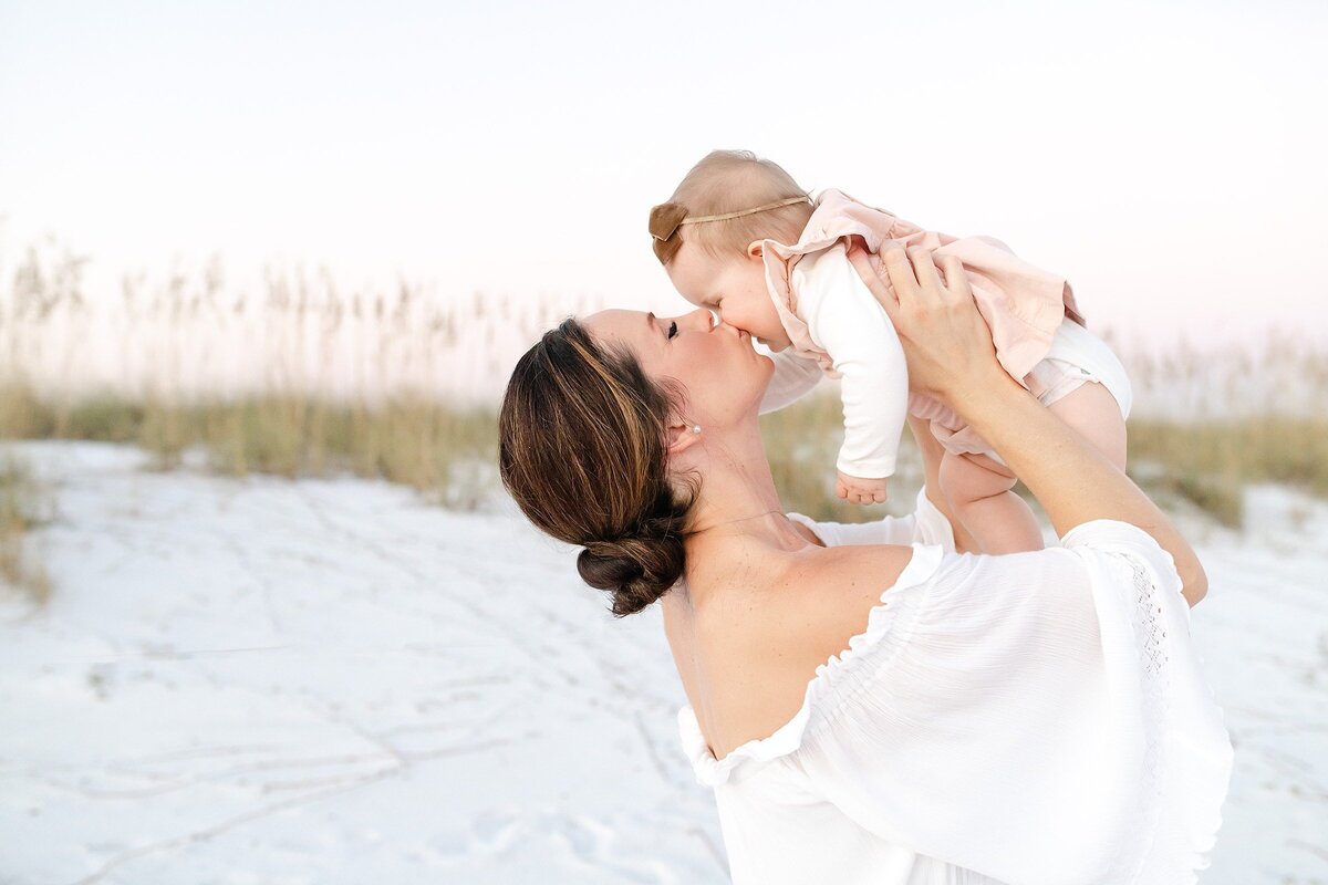 mom holding up a baby with destin family photographers