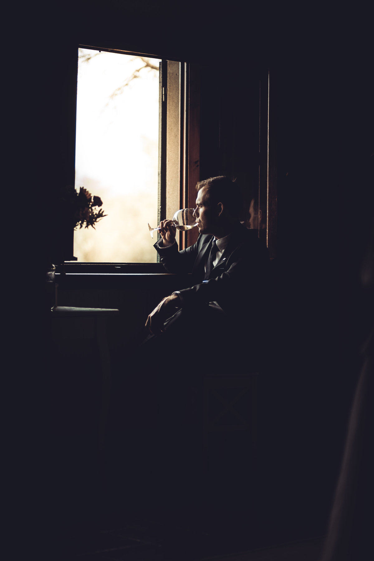 Groom By Window Photography