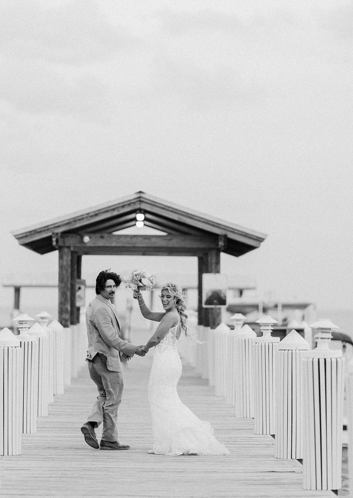 Newlyweds Brenda & Stephen joyfully raising hands after their vows at Cheeca Lodge.