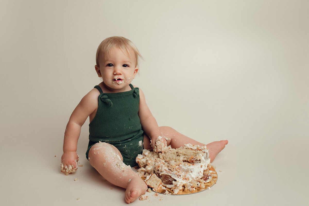 a one year old boy with a completely destroyed cake in rochester ny