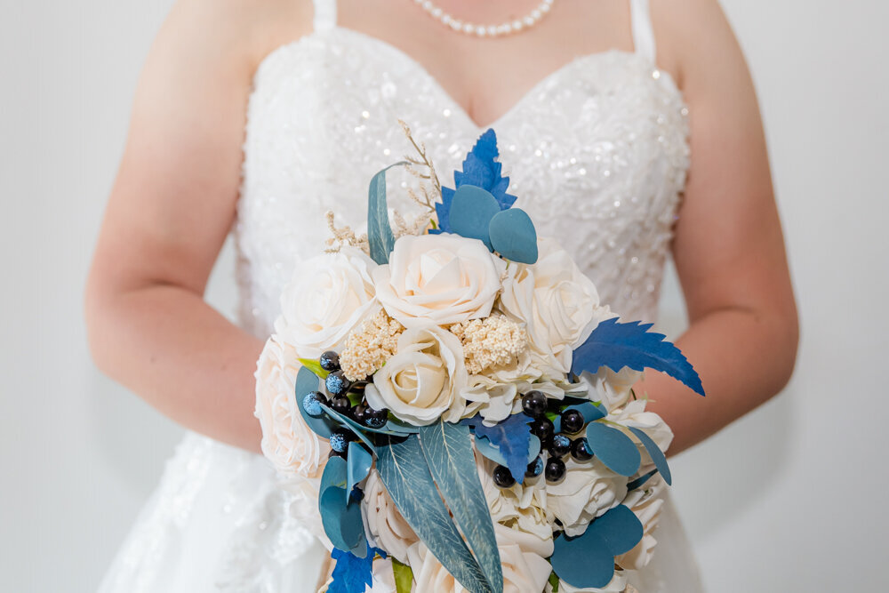 detail shot of bride with her bouquet against her wedding gown - Townsville Wedding Photography by Jamie Simmons