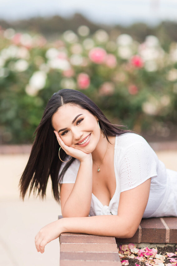 Senior girl with head in hands