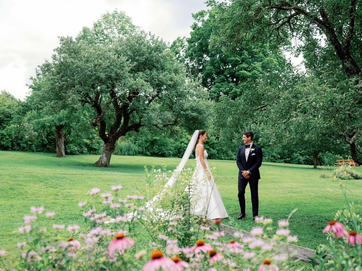 bride and groom walk through the gardens at hildene wedding in manchster, vt