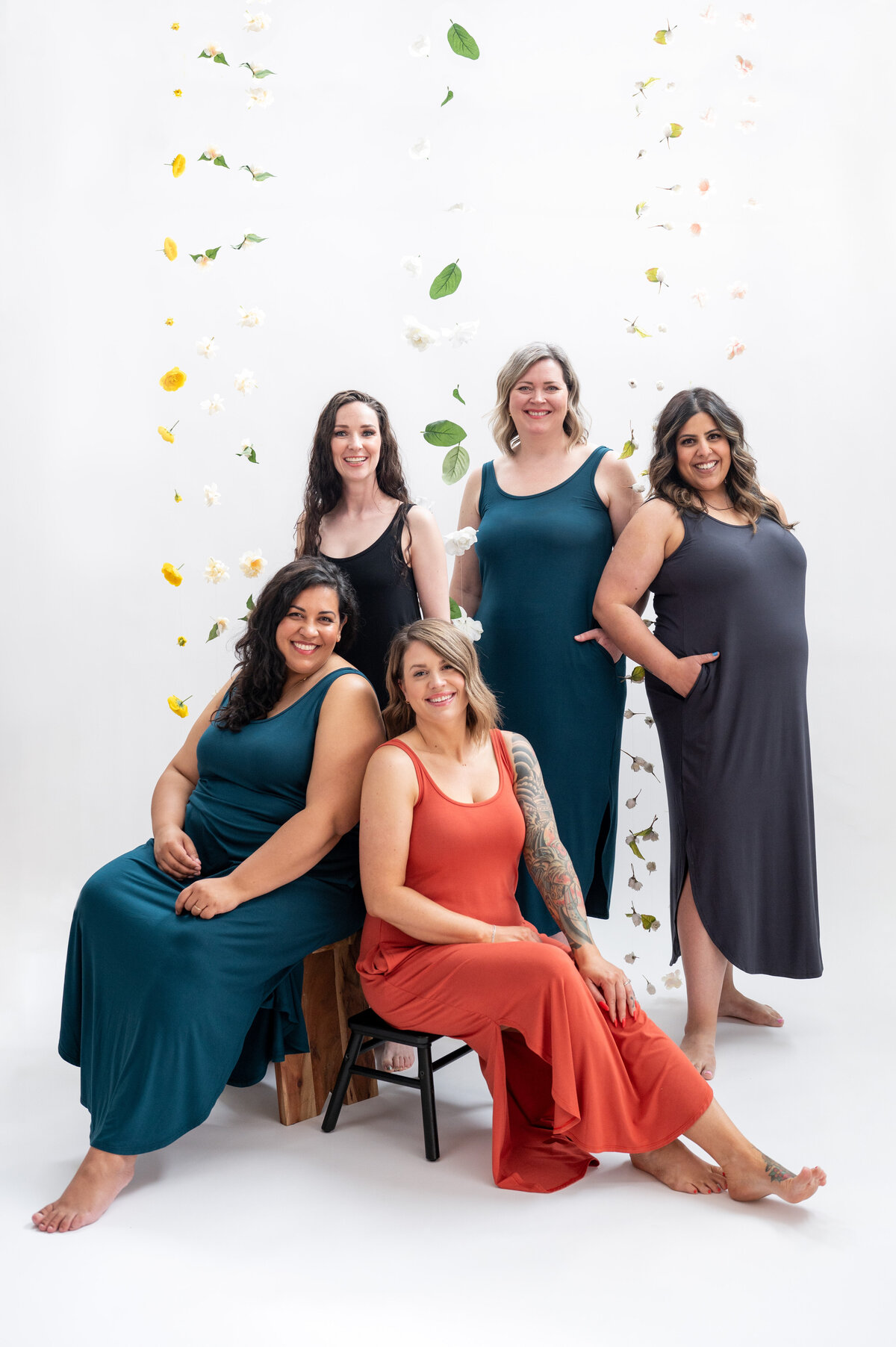 Listing photo of 5 women wearing maxi dresses on a flower backdrop