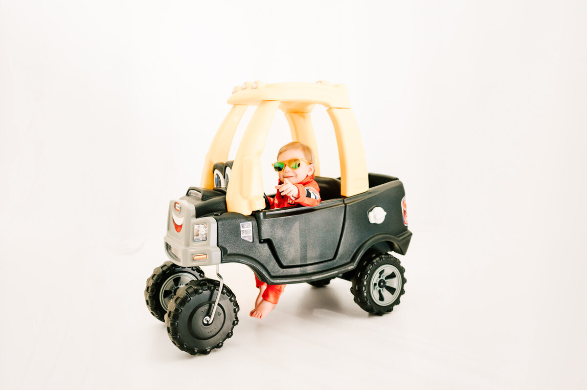Springfield MO kids photographer captures baby boy sitting in tike car
