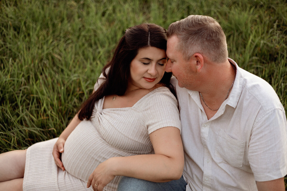 outdoor maternity session cuddled up with spouse