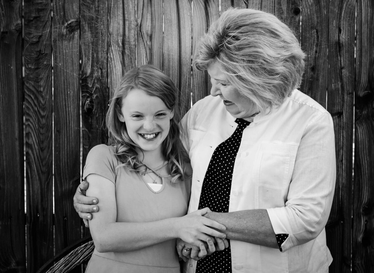 Girl laughs with grandmother in session with Prescott family photographer Melissa Byrne
