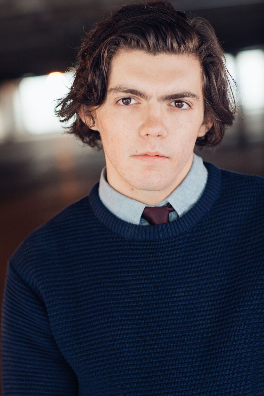 Young Man Wearing Navy Blue Cotton Sweater with Inner Sky Blue Long Sleeve and Maroon Necktie Headshot in LA