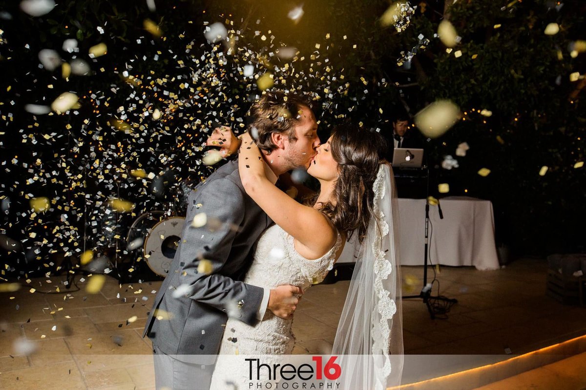 Groom kisses his Bride on the dance floor