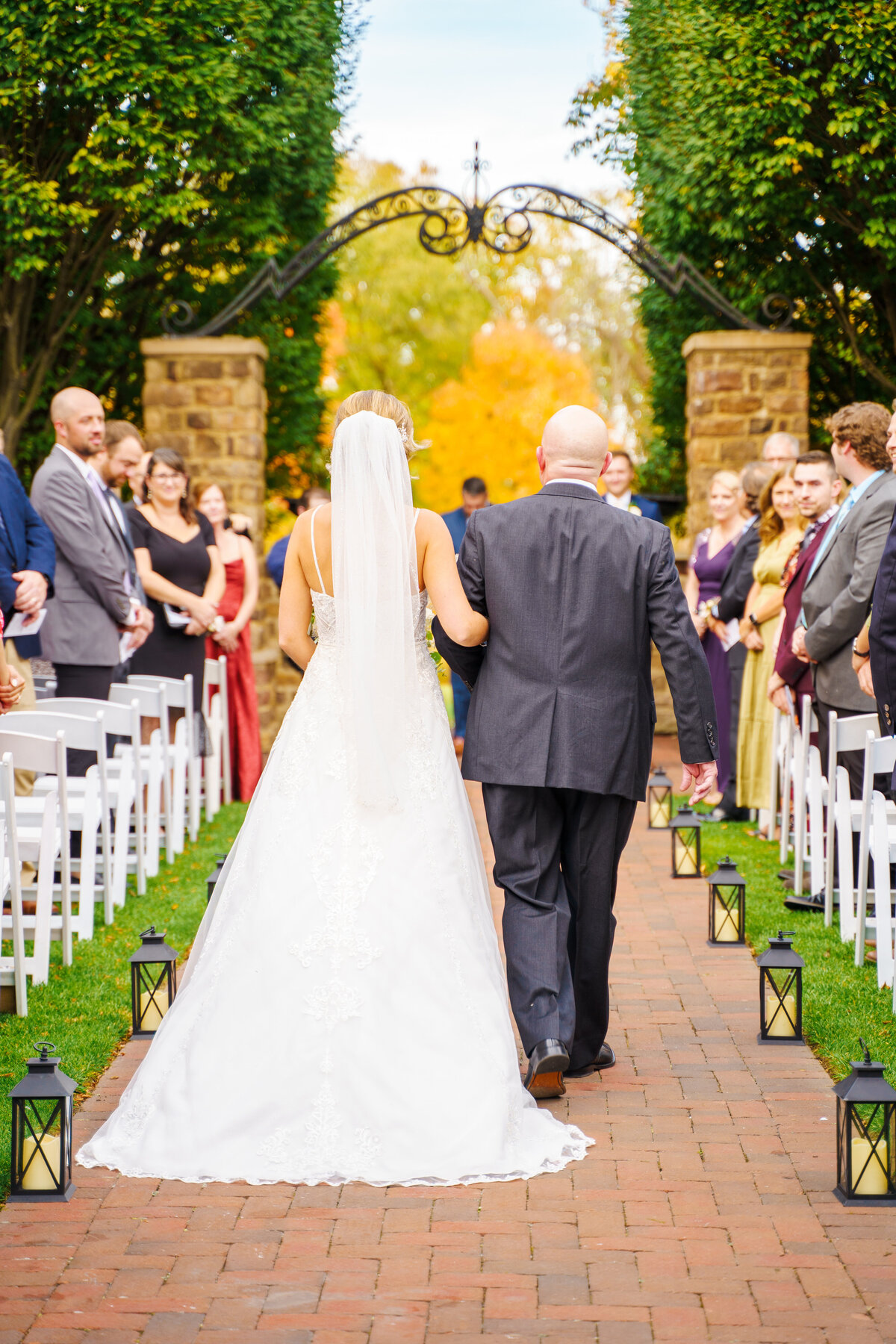Bride walks down the aisle with her dad at her wedding at The Pinnacle Golf Course in Grove City, Ohio.