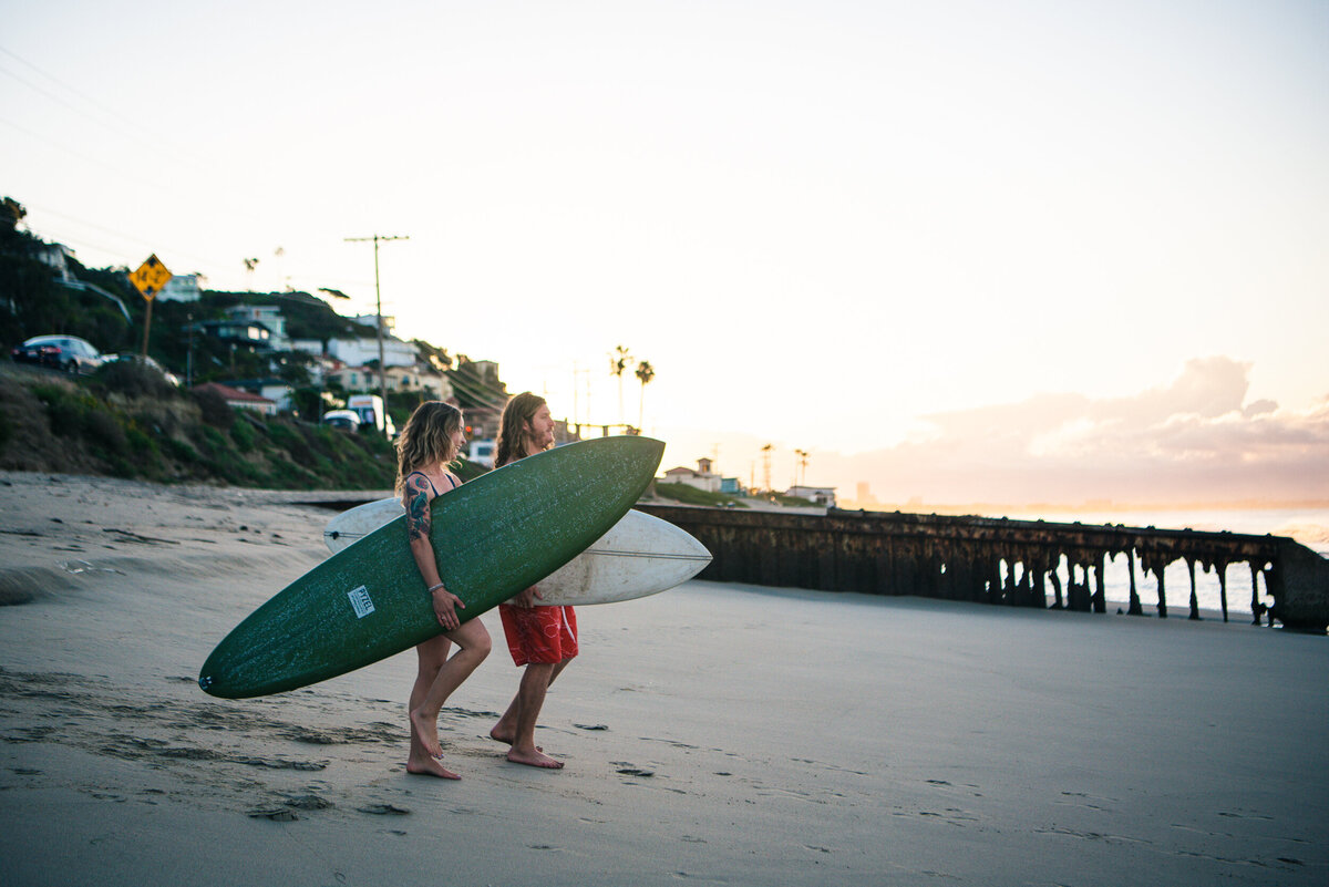 Coupel with surfboards on Los Angeles Beach