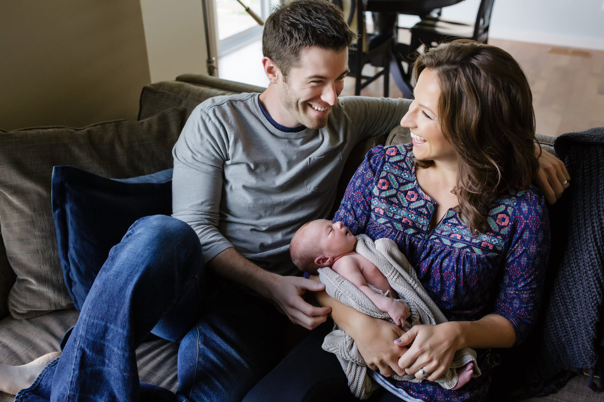 Parents looking at each other with newborn - Jen Madigan - Naperville Lifestyle Newborn Photographer