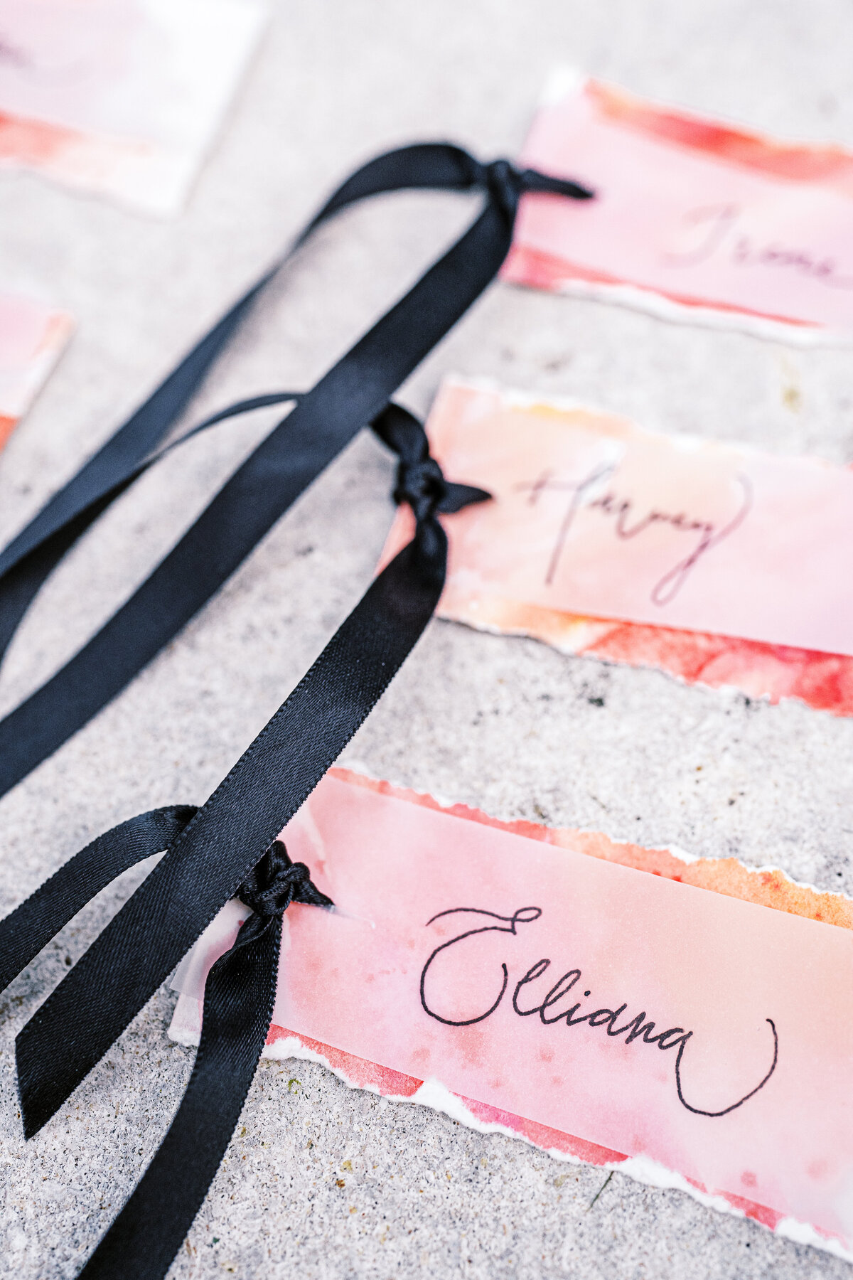Colorful name cards with calligraphy and black ribbon photographed by Lake Como Wedding photographer