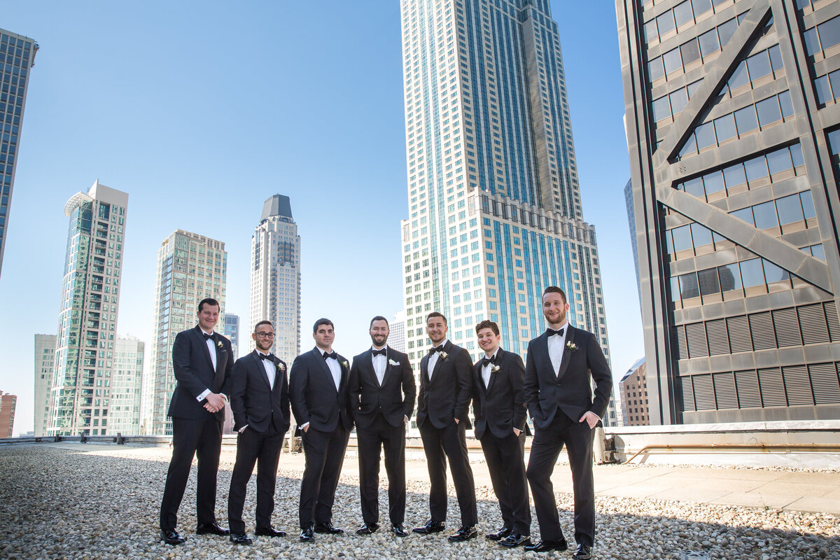 Groomsmen posing for a photo on the roof of the Ritz Carlton in Chicago, IL