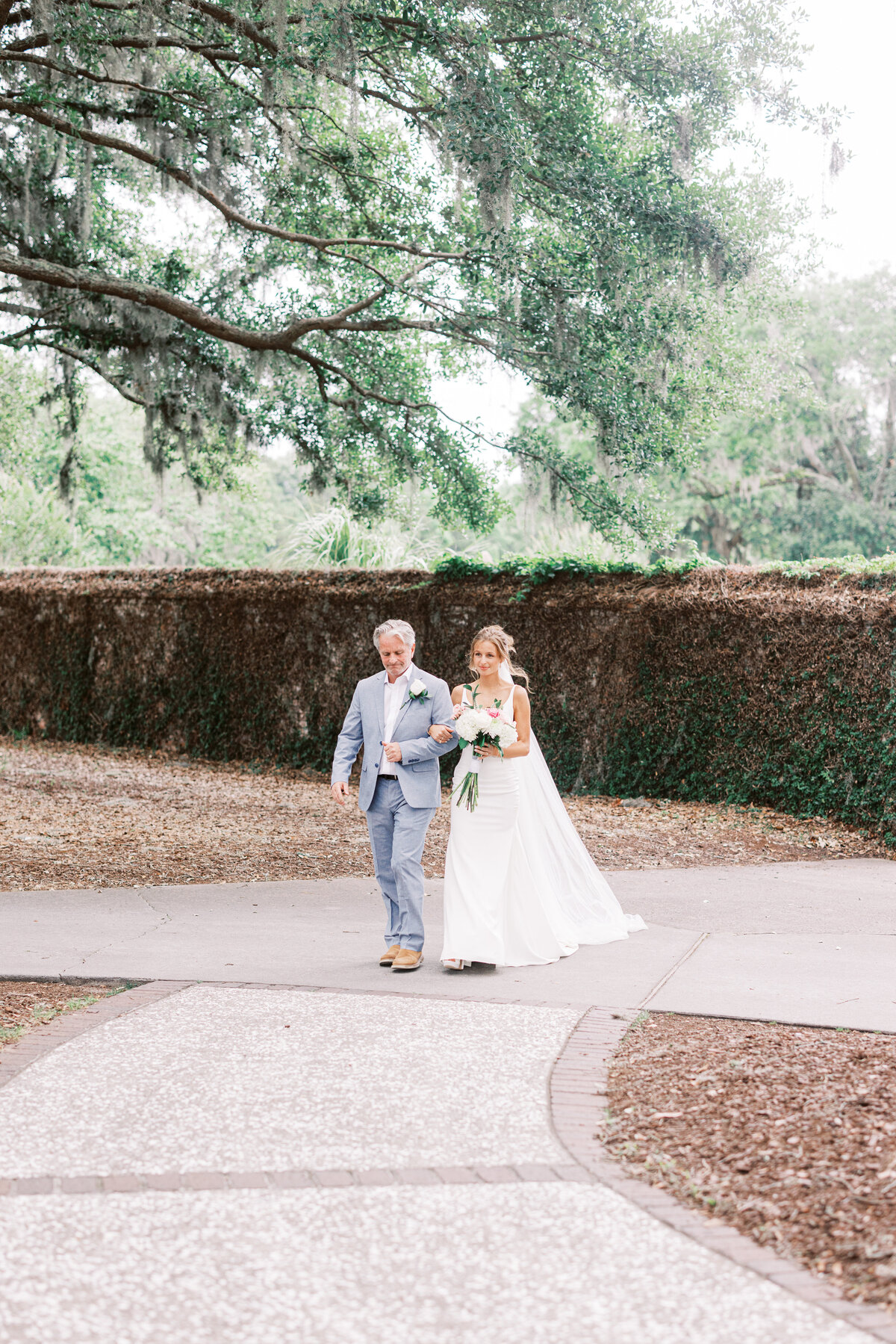 Father walking his daughter down the aisle at her wedding in Charleston