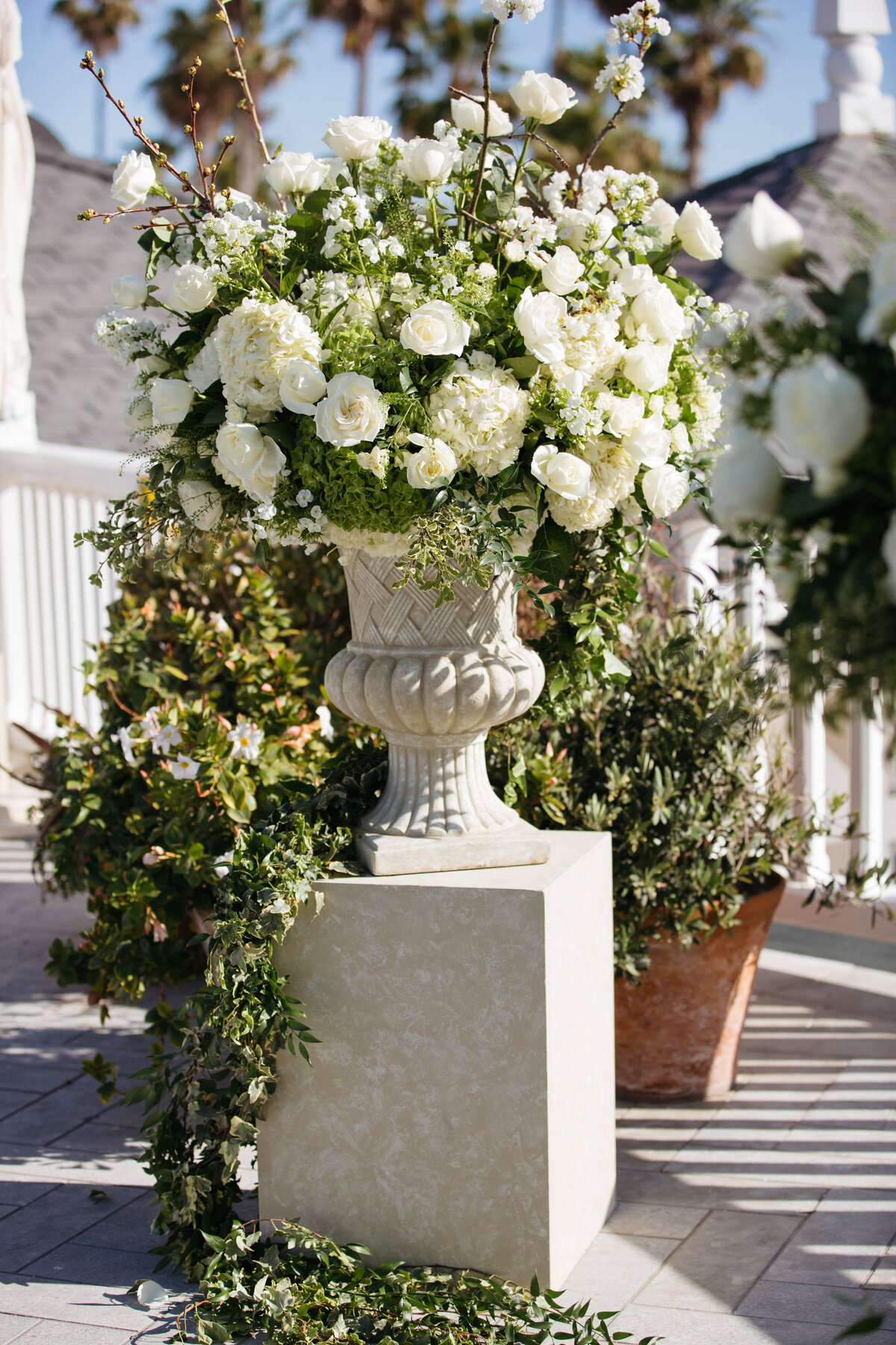 A large floral arrangement on a small pillar