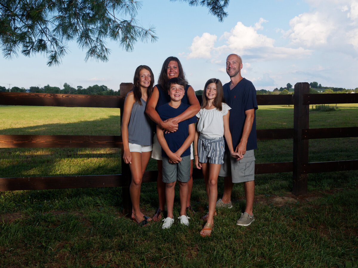 family by fence outdoor daytime portrait