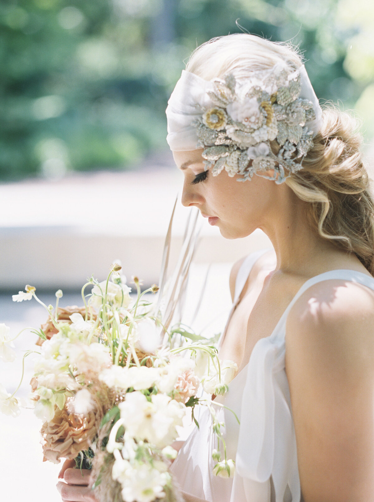 A Lady looks demure profile shot in her wedding headscarf.