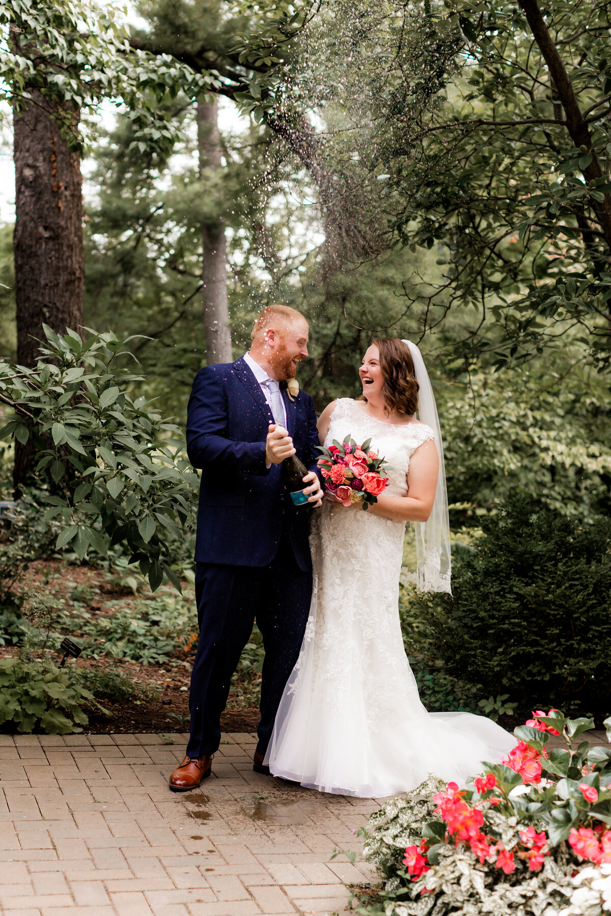 A couple share a champagne pop on their wedding day.