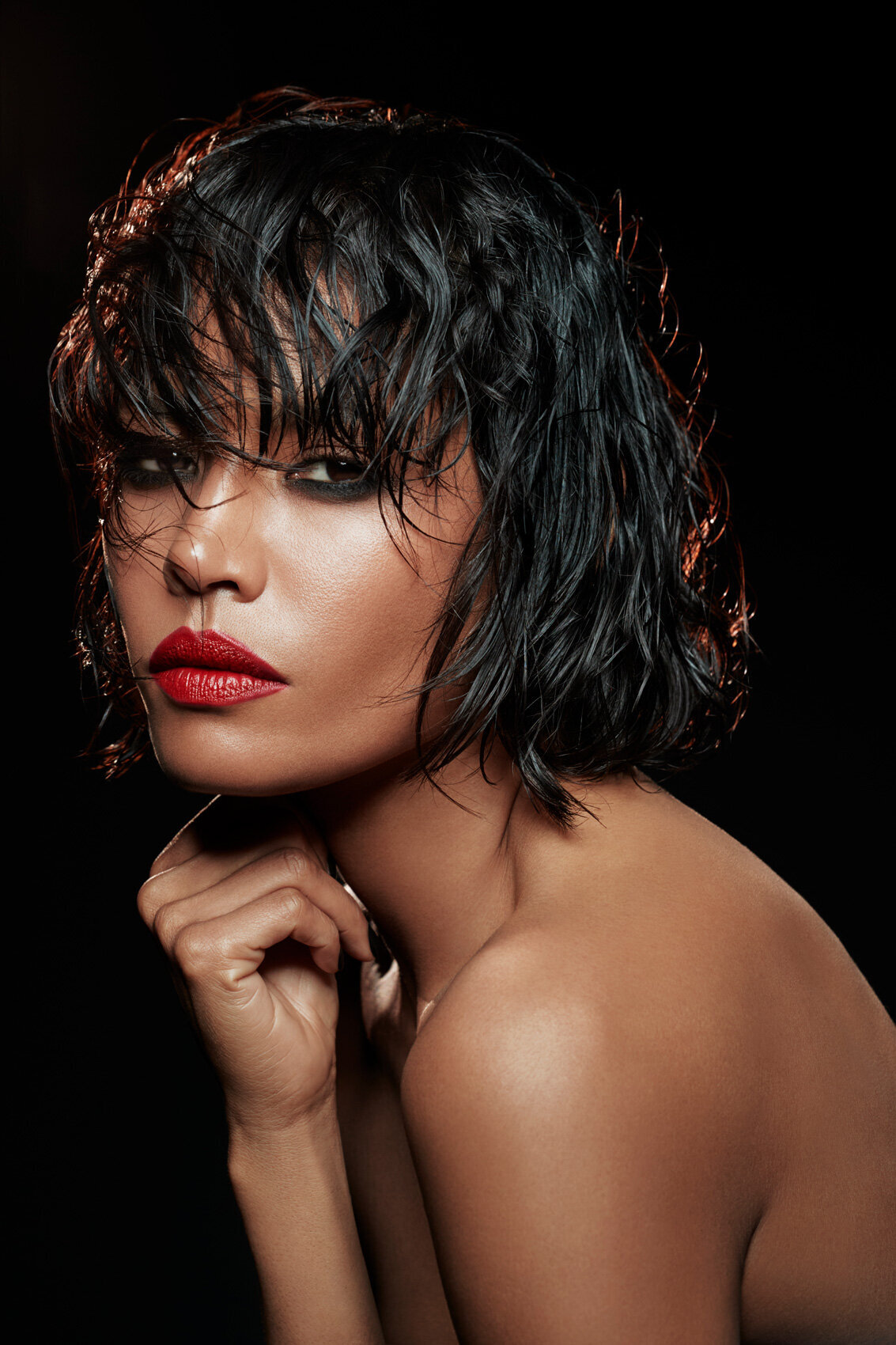 Elegant portrait of Amira with bold red lipstick and a sleek hairstyle, captured by Ylva Erevall for a YSL campaign.