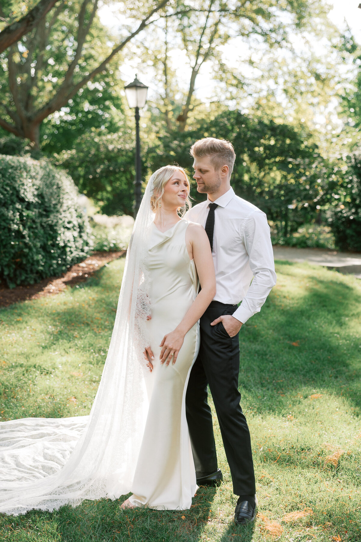 Bride and groom share a moment on lush lawn at Dayton, Ohio wedding, captured by Philadelphia photographer.