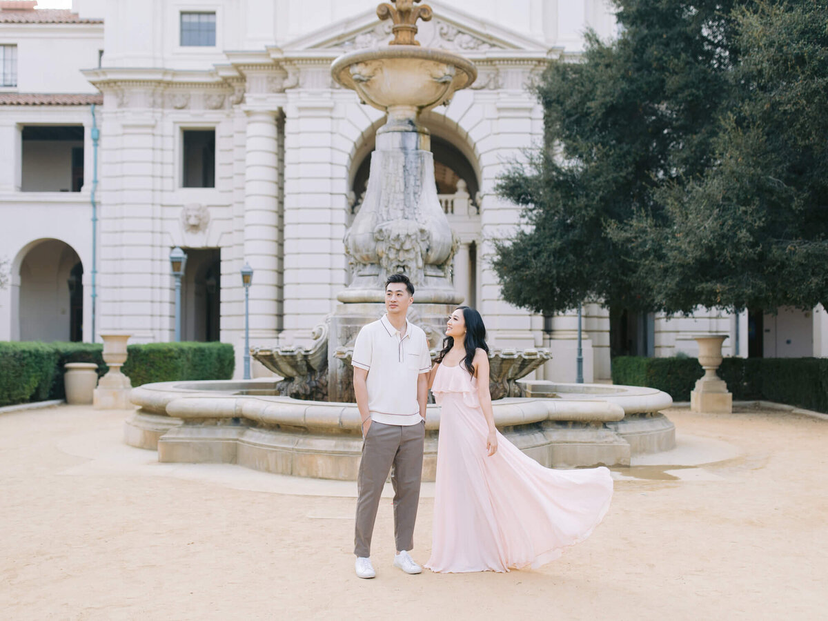 couple standing in front of pasadena city hall water fountain